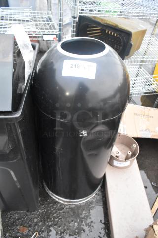 Black metal trash can shell, cylindrical shape, glossy finish, minor scuffs. Label reads "WHITE" and displays "219 QTY 1".