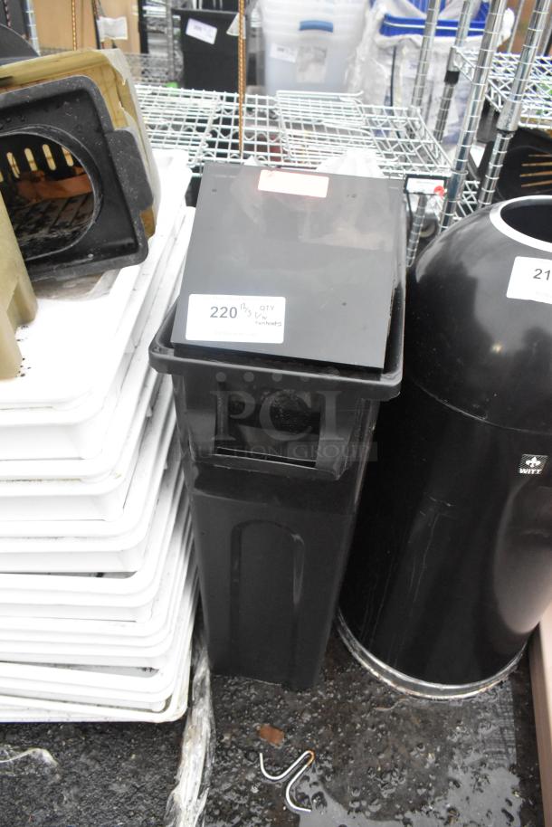 Black Poly Slim Jim trash can with contents, slightly worn condition, labeled "220 QTY" for auction identification.