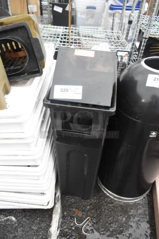 Black Poly Slim Jim trash can with contents, slightly worn condition, labeled "220 QTY" for auction identification.