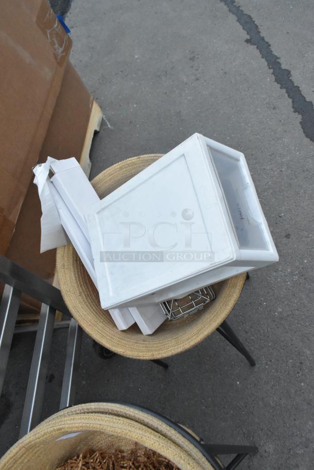 Pair of black metal basket stands, featuring sturdy design and modern look. Includes removable trays for versatile use.