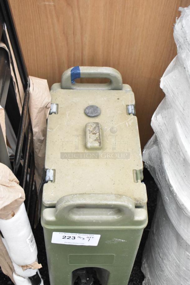 Green Poly Beverage Holder Dispenser with handles, used condition. Label reads "223" and shows signs of wear.