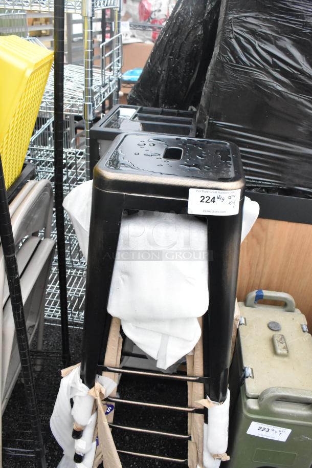 4 brand new scratch and dent black metal Tolix style stools stacked, auction ID 224, quantity 4.