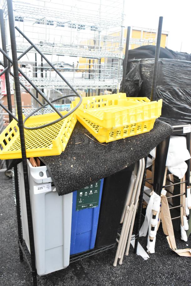 Two-tier black wire shelving unit with Slim Jim trash cans, yellow crates, and other contents. Buyer must dismantle.