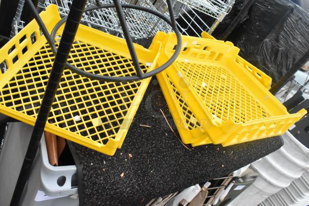 Black finish 2-tier wire shelving unit with yellow plastic trays and Slim Jim trash cans; buyer must dismantle.