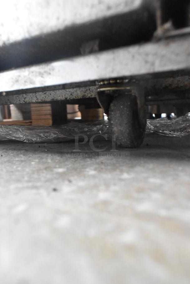 Pitco Frialator stainless steel commercial fryer oil filtration system, visible caster for mobility.