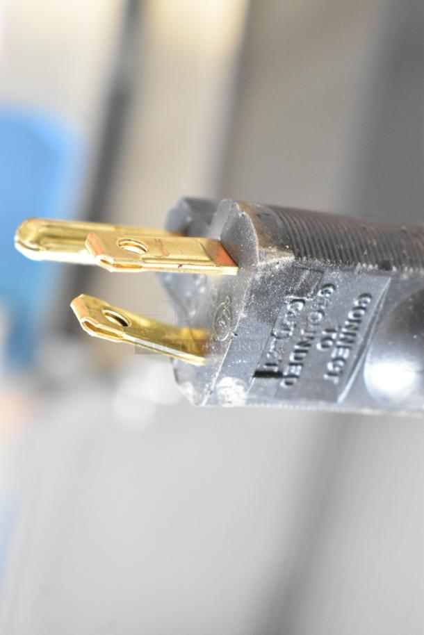 Close-up of a plug from a Prince Castle 297-T9 commercial toaster, showing prongs and "Connect Ground" imprint.