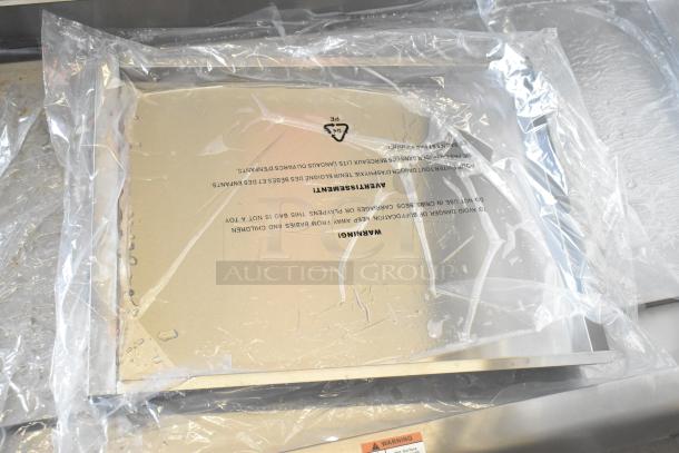 Brand new Cooking Performance Group 48" gas griddle, model 351GTCPG48NL, in packaging; tags indicating safety warnings.