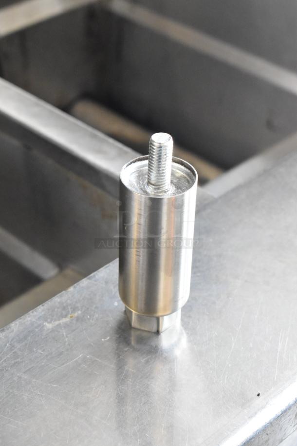 Stainless steel component of Avantco 177EG24N griddle. Shows surface detail and part of the griddle structure.