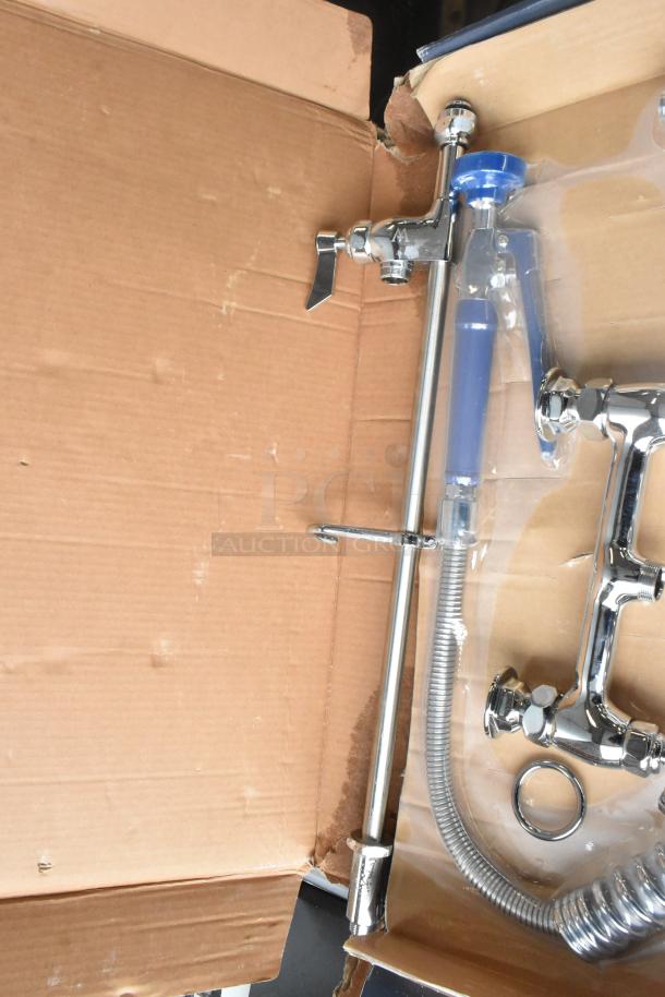 BRAND NEW 750PRD812 Waterloo pre-rinse faucet with 8" centers, 12" add-on faucet in open box, showing minor dents.