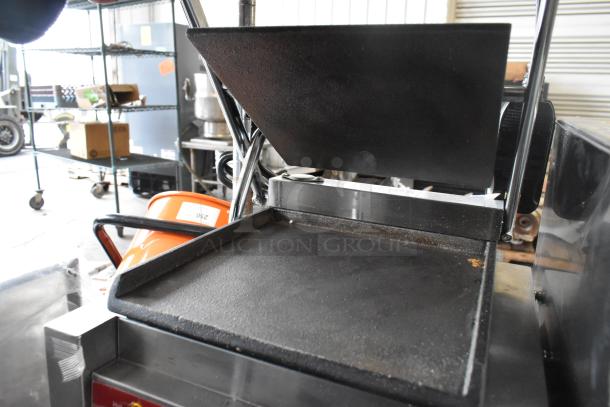 Brand new 2025 Avantco 177PG100ST stainless steel panini grill, smooth plates, 8.5"x8.5" surface, visible scratch and dent.