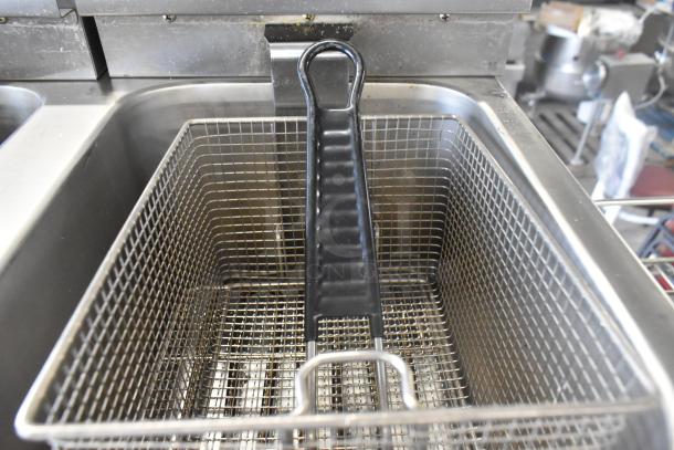 Brand new Avantco 177F202 dual tank electric fryer, 30 lb capacity, stainless steel, with two metal baskets and lids.