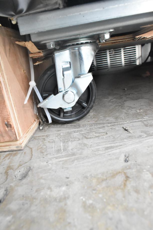 Commercial caster wheel of Avantco 178SS1RHC reach-in cooler, showing sturdy metal construction and mobility features.