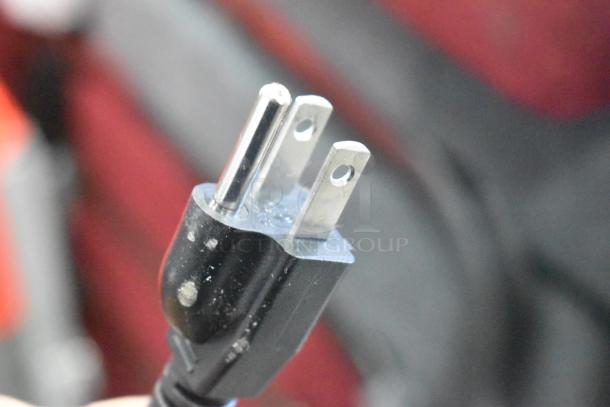 Close-up of the plug for Carnival King PM1360 popcorn machine, showing a standard three-prong design.