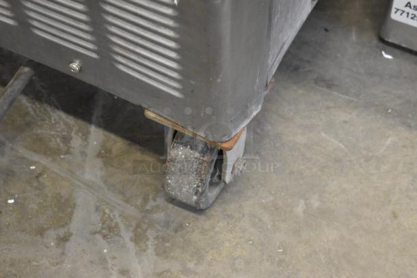 Taylor 754-27 stainless steel soft serve ice cream machine on commercial caster; floor style, used condition.