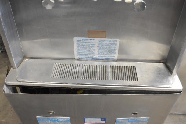 Taylor 754-27 stainless steel soft serve machine, air-cooled, 2 flavors with twist, on commercial casters.
