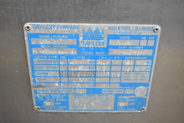 Taylor 754-27 stainless steel soft serve machine label, detailing model, serial number, voltage, and motor specs.