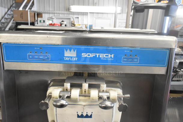 Taylor 754-27 stainless steel commercial soft serve ice cream machine with 2 flavors and twist, on casters, air-cooled.