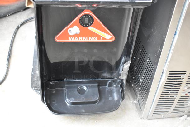 Brand new Stoelting C111-37 soft serve machine, 115V, 1 phase. Scratch and dent condition with warning label visible.