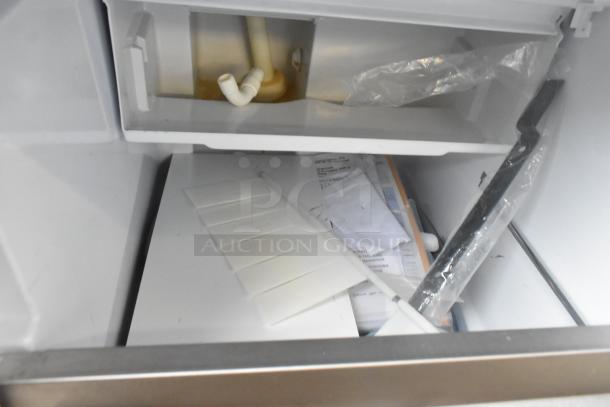 Brand new Scotsman UC0918GAX-1A stainless steel commercial ice machine with visible packaging components.