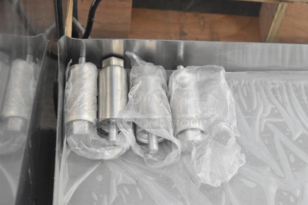 Avantco 177EG30N stainless steel griddle parts wrapped in plastic; brand new condition with minor scratches.