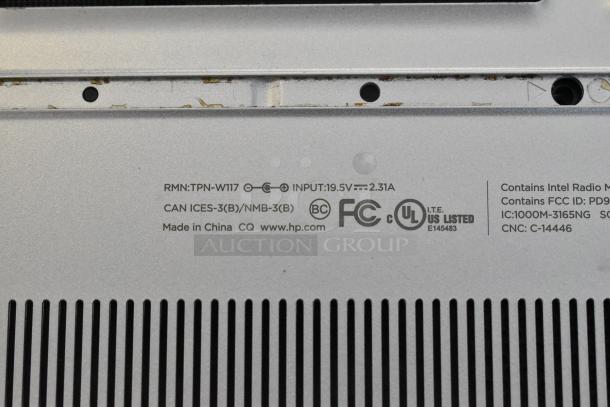 HP m1-u001dx laptop underside with visible specifications: RMN TPN-W117, input 19.5V, 2.31A, FCC and UL listed.
