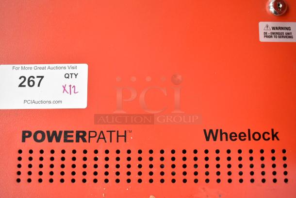 12 Wheelock PowerPath SP40S red metal fire and emergency systems. Label shows "QTY x12" and warning for de-energizing unit.