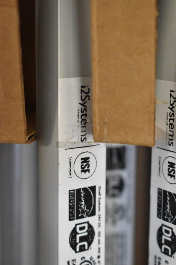 Boxes containing i2Systems lights, showing NSF and DLC labels, indicating energy efficiency and compliance.