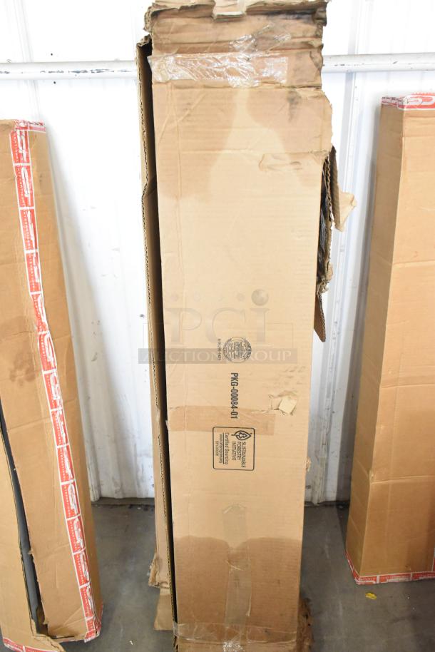 Nine various iSystems Lights boxes, visible wear, tape remnants, marked "PKG-00084-01," stored in a warehouse setting.