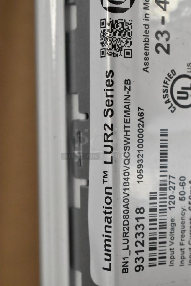 Close-up of Lumination LUR2 Series label with input voltage 120-277V and frequency 50-60Hz, indicating product specifications.