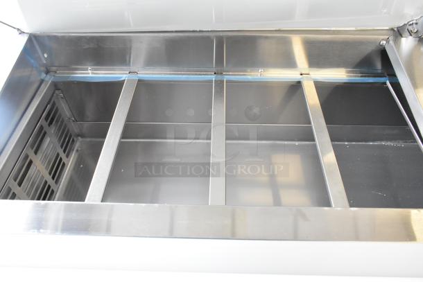 Brand new Avantco 178APPT71HC stainless steel commercial pizza prep table, 115V, 1-phase, showing interior compartment.