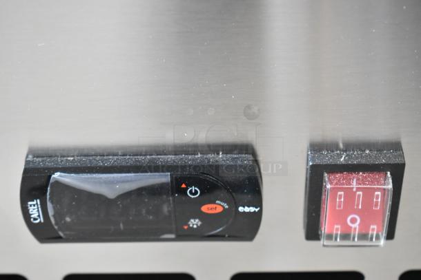 Stainless steel control panel of Avantco 178APPT71HC pizza prep table, featuring a digital display by CAREL and red power switch.