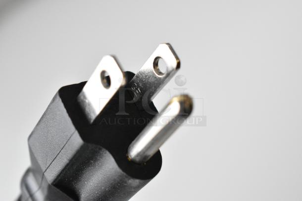 Close-up of a three-prong plug, possibly part of the Avantco 178APPT71HC Stainless Steel Commercial Pizza Prep Table.