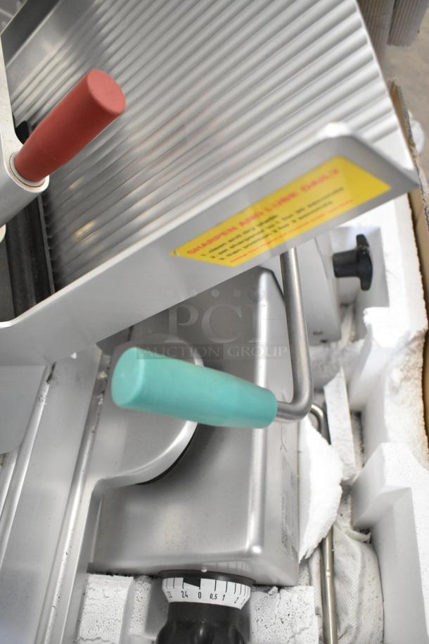 2018 Bizerba GSP H metal commercial meat slicer, red and green handles, 120V, 1 phase, dial visible, stainless steel.