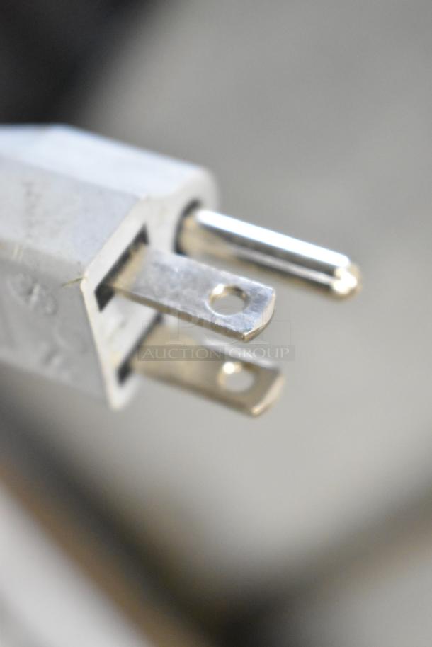 Close-up of a metal plug for a 2018 Bizerba GSP H meat slicer, showing three-prong connection for 120V, 1-phase power.