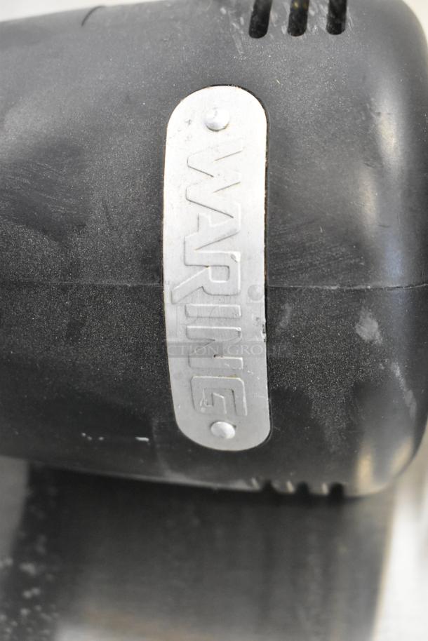 Waring WSB immersion blender, black casing, visible "Waring" label. 120 volts, 1 phase. Used condition.