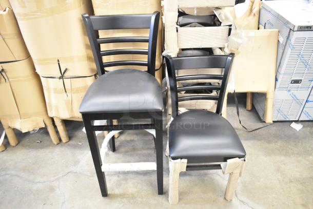 42 Lancaster Table & Seating stools: black wood, ladder back design, black vinyl seats, dining and bar height, scratch and dent condition.