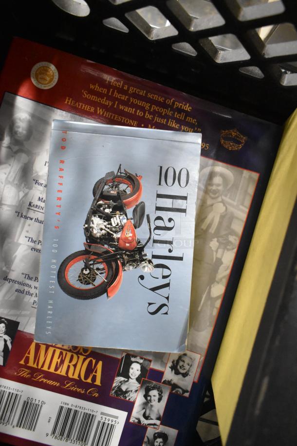 Auction lot featuring "100 Harleys" book on classic motorcycles, a book about "Miss America" pageants, and other collectible items.