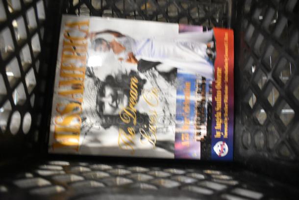 Collection of various items including a "Miss America" book visible in a crate. Items are part of a mixed auction lot.