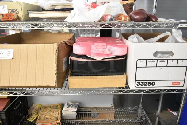 Auction tier lot with various items on shelves including ceramic containers, state plates, pink ring pool, and vintage items.