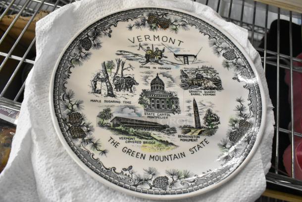 Vermont souvenir plate, ceramic, features state landmarks like State Capitol, covered bridge. Good condition.