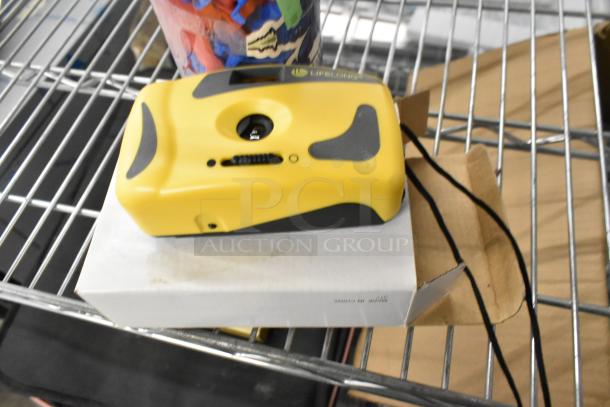 Yellow disposable camera with black accents, Lifelong brand, on a shelf next to a container of toy figurines.