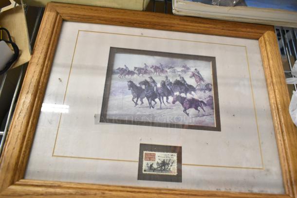 Framed art print depicting horsemen in battle with a commemorative U.S. postage stamp, housed in a wooden frame.