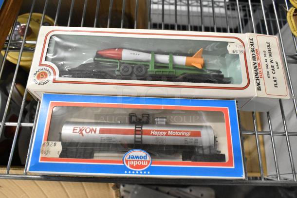 Bachmann HO Scale Flat Car Missile and Model Power Exxon Tank Car in original boxes; vintage collectibles, good condition.