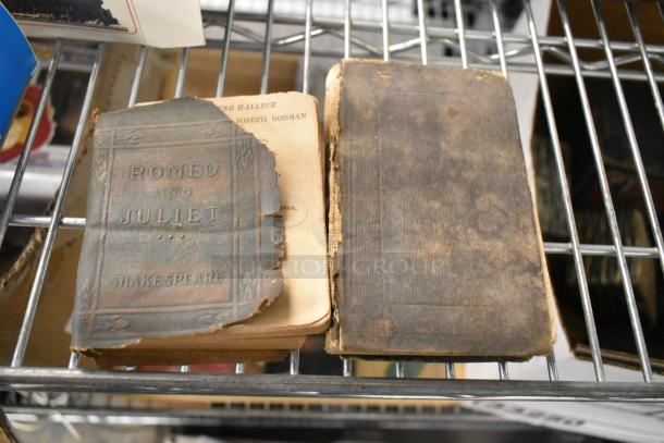 Vintage "Romeo and Juliet" book with worn cover, alongside another aged book on a metal shelf.