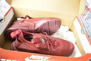 Red Nike Huarache Drift (GS) sneakers, size 4Y, in original box. Mesh and synthetic upper, lightly worn, visible tread.