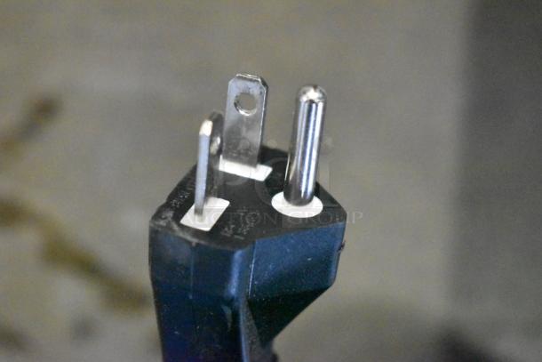 Close-up of a power plug for the Avantco 177IC3500P induction range, showing three prongs and a dark casing.