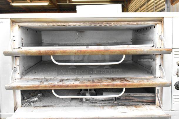 Blodgett stainless steel 2-deck commercial gas pizza oven. Features two baking chambers. Used condition with rust and wear.