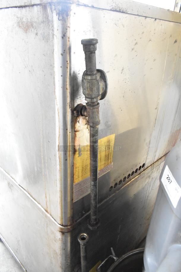 Blodgett stainless steel commercial pizza oven, 2 deck, gas-powered, showing wear on exterior. Visible pipe and labels on side.