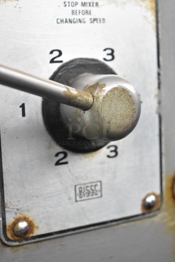 Close-up of Hobart L 800 mixer's speed control dial with numbering. Shows wear and BISSC certification mark.