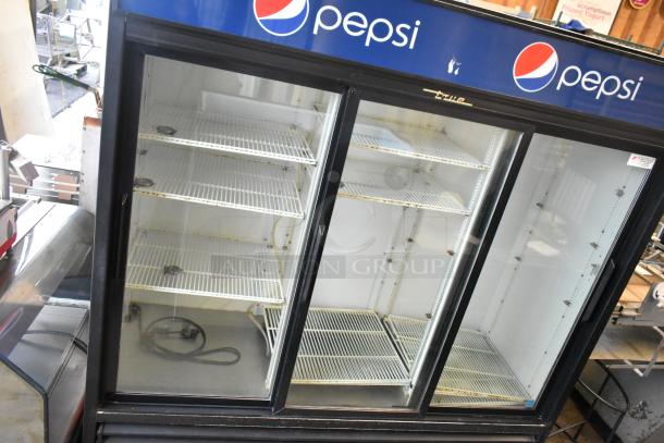 True GDM-69 commercial 3-door cooler with poly-coated racks, Pepsi branding. Used condition, 115 volts, 1 phase.